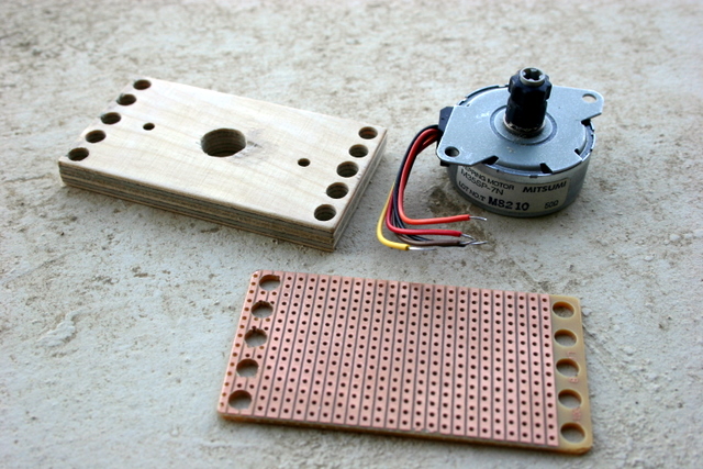The motor with the Technic gear, the board, and a prototyping PCB for the controller